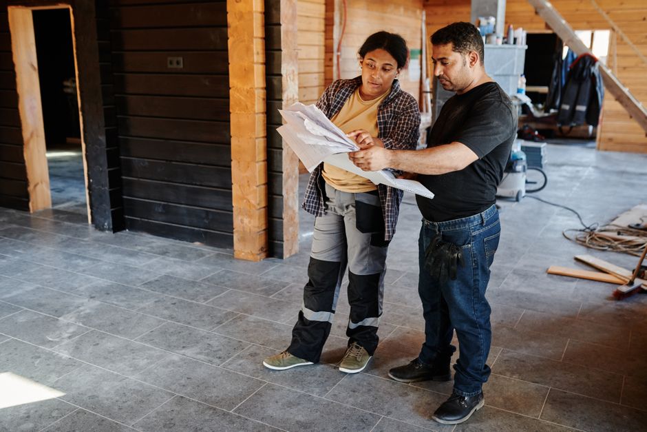 General contractor reviewing blueprints for a home renovation